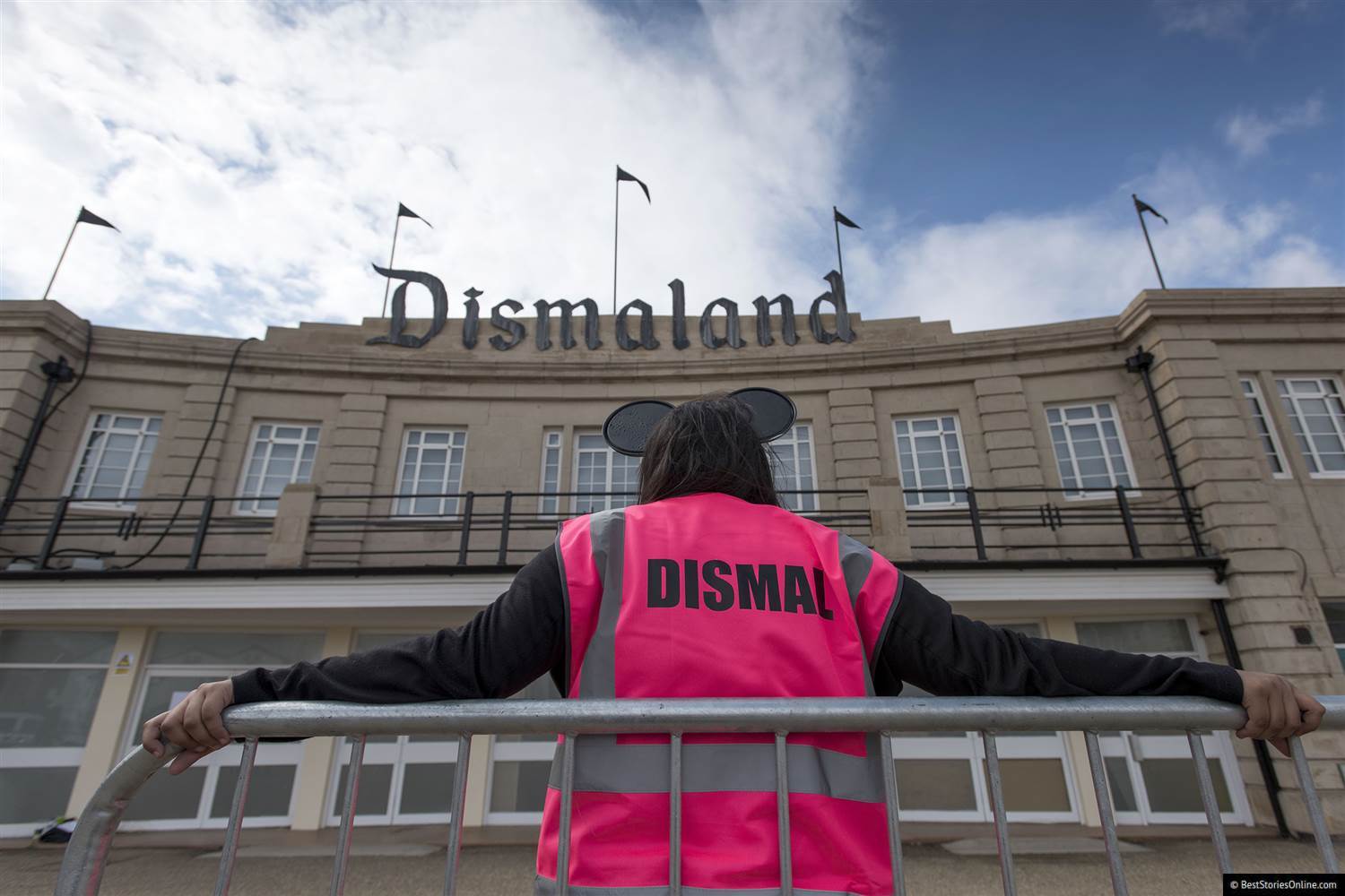 Pictured: A ‘Dismaland’ employee slacks off outside the exhibition’s entrance.